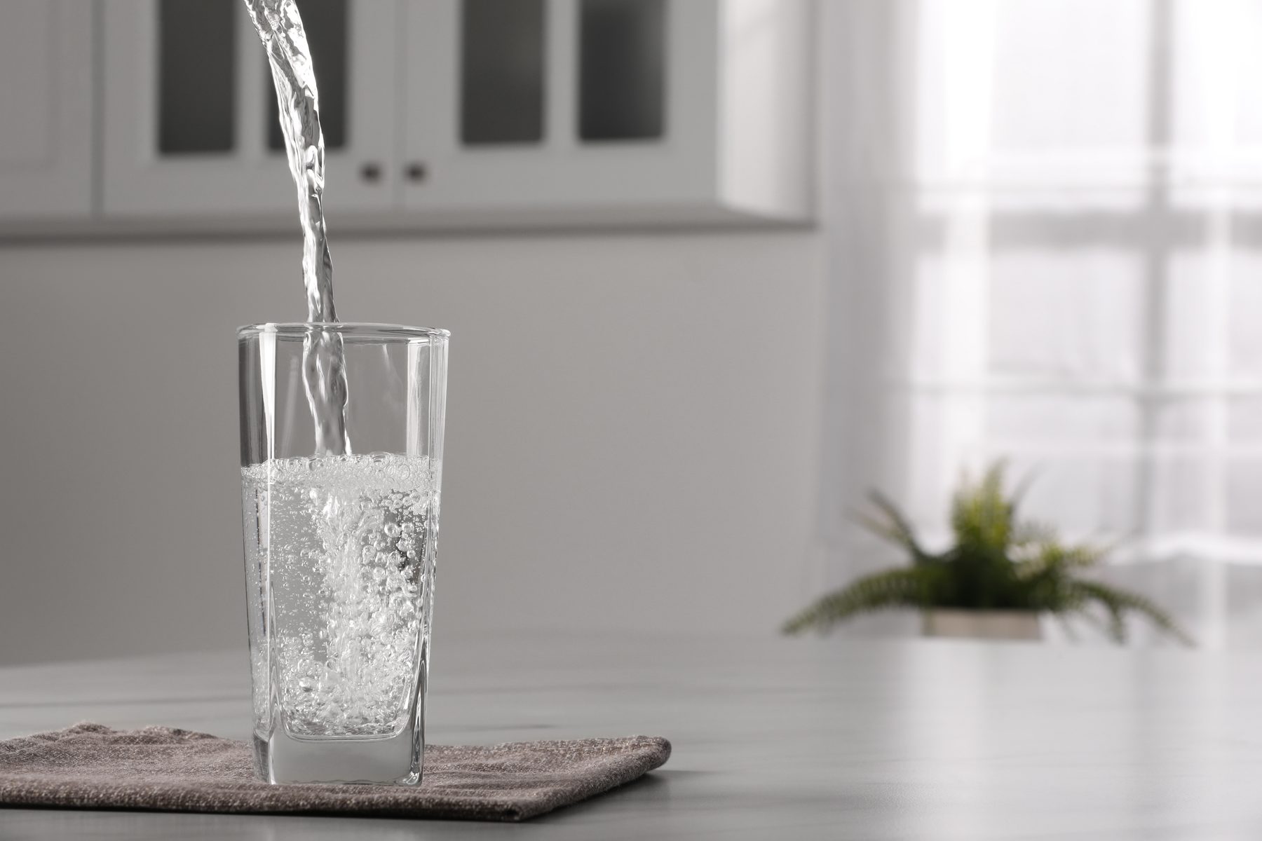 Clear drinking water being poured into a glass