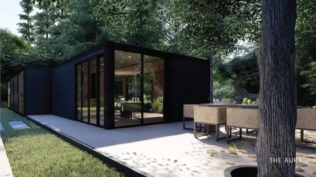 The Aura, a single-story PLAD steel structure home in black with full-height glass walls and a concrete patio