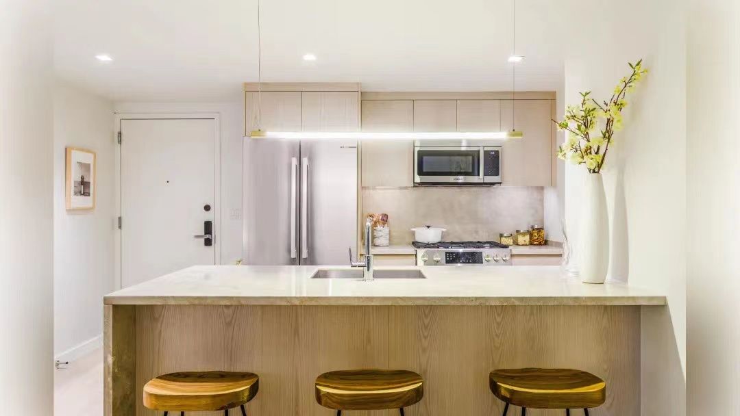 Suofeiya kitchen cabinets and island with counter stools in a New York apartment